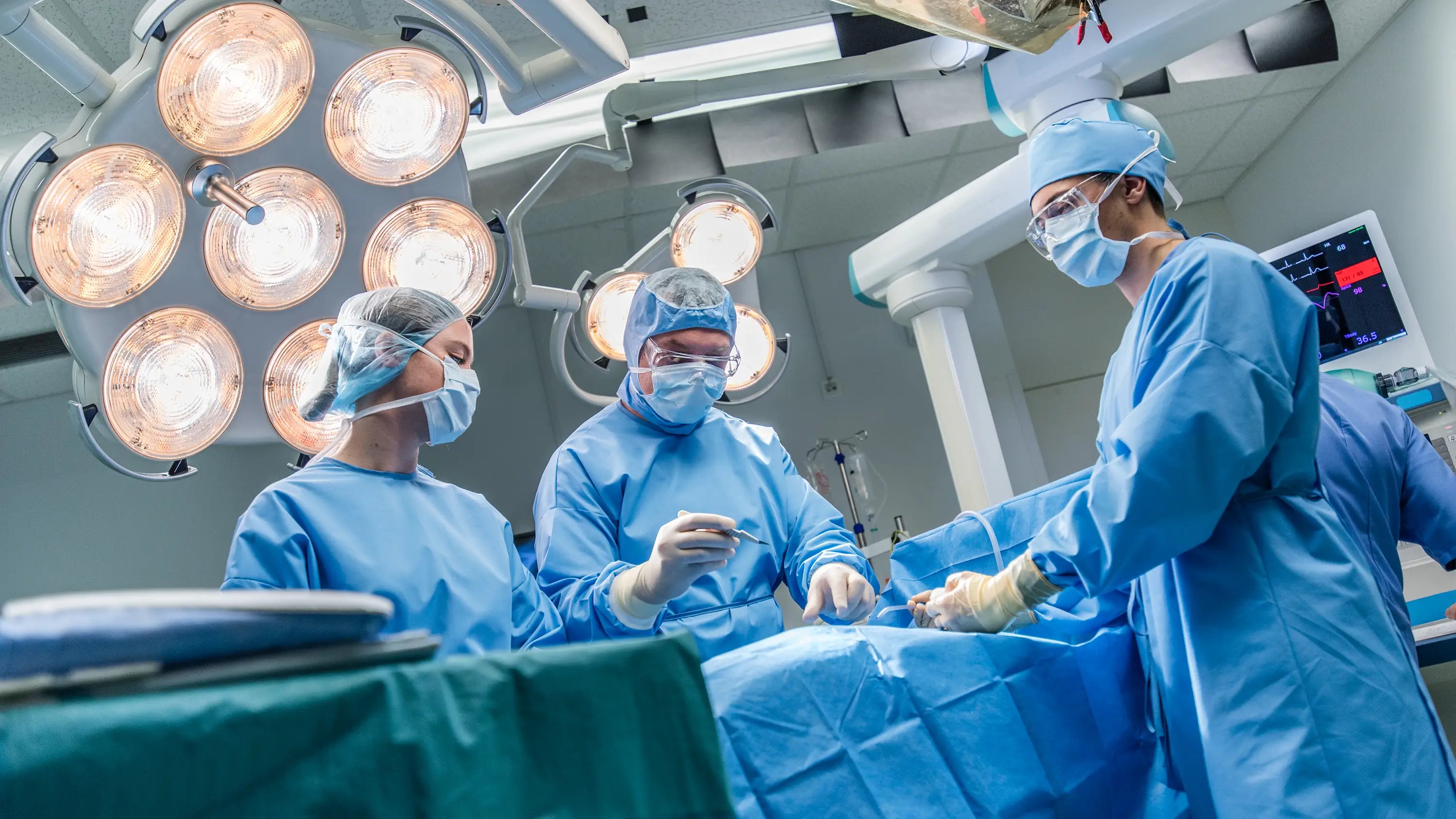 Surgeons in an operating room using Paragon Medical precision surgical instruments
